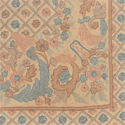 Aubusson design pale peach ground rug, woven with an all-over lattice design in rose and cyan with central floral bouquet medallion, the scrolling acanthi and flowerhead spandrels contained within a lattice guard band