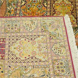 Late 20th-century Persian panel design silk and cotton blend rug, in pale tones of ivory, pistachio, green, crimson, pale blue, and rose, each compartment enclosing a stylized mihrab, boteh, cypress, and floral motifs, framed by a narrow floral border with guard stripes and cotton fringe ends 