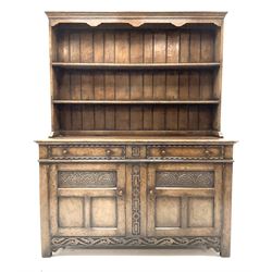 Jacobean style carved oak dresser fitted two drawers and two cupboards, with plate rack