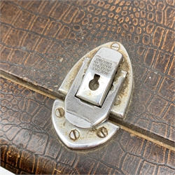 A vintage mid 20th Century cased Singer manual sewing machine, within faux crocodile carry case.