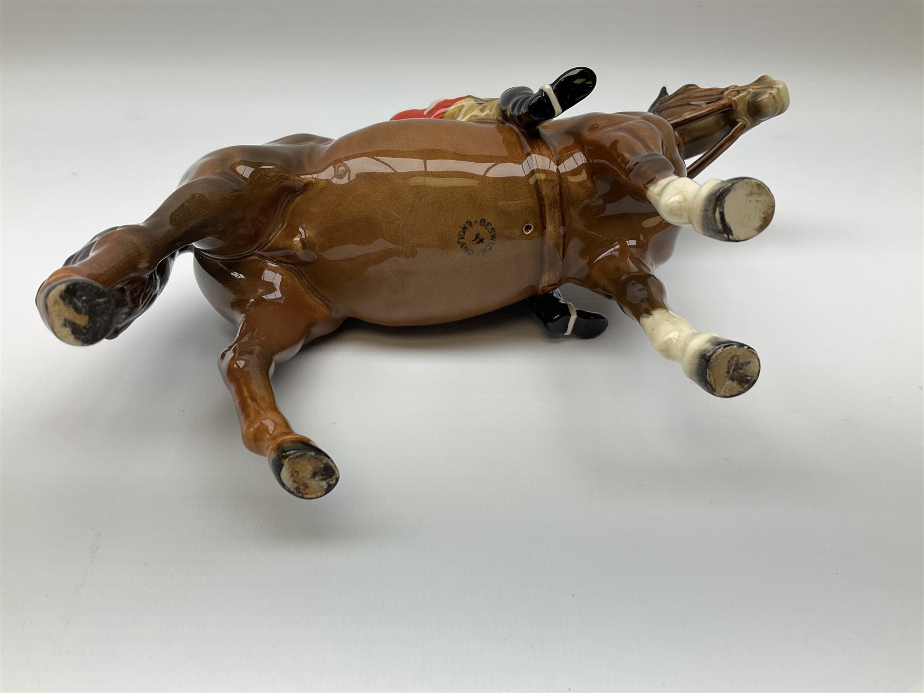 Beswick model of a huntswoman on grey horse model no 1730, and Beswick huntsman on brown horse model no 1501, both with printed mark beneath. 