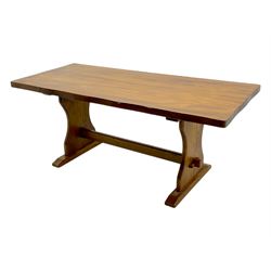 Late 20th century oak trestle table, rectangular top with naturalistic edge, supported by two curved pedestal bases united by central stretcher, on block feet