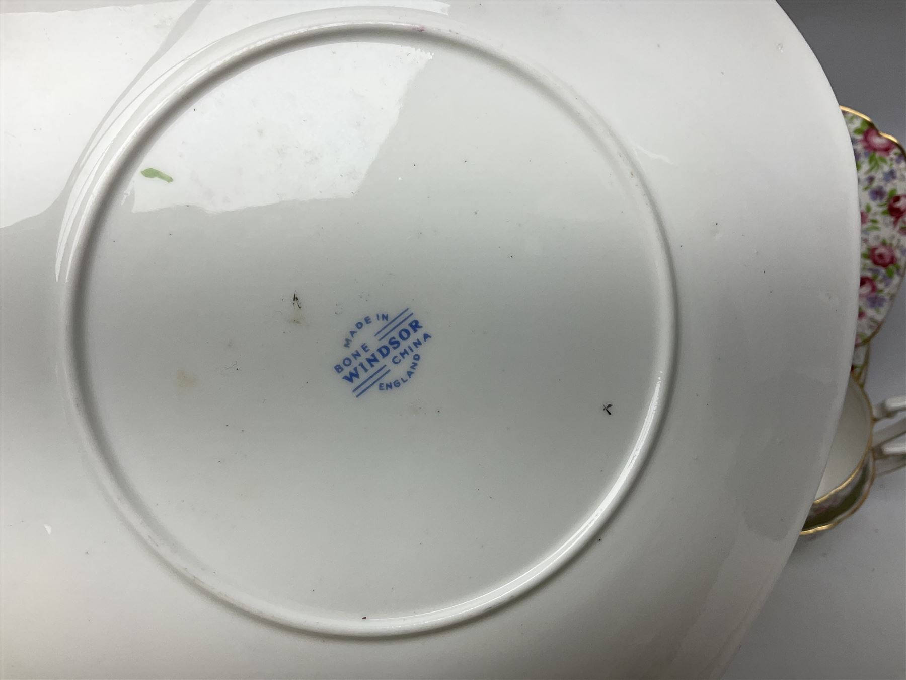 Windsor tea service for six decorated with blooming pink roses and purple flowers amongst foliage