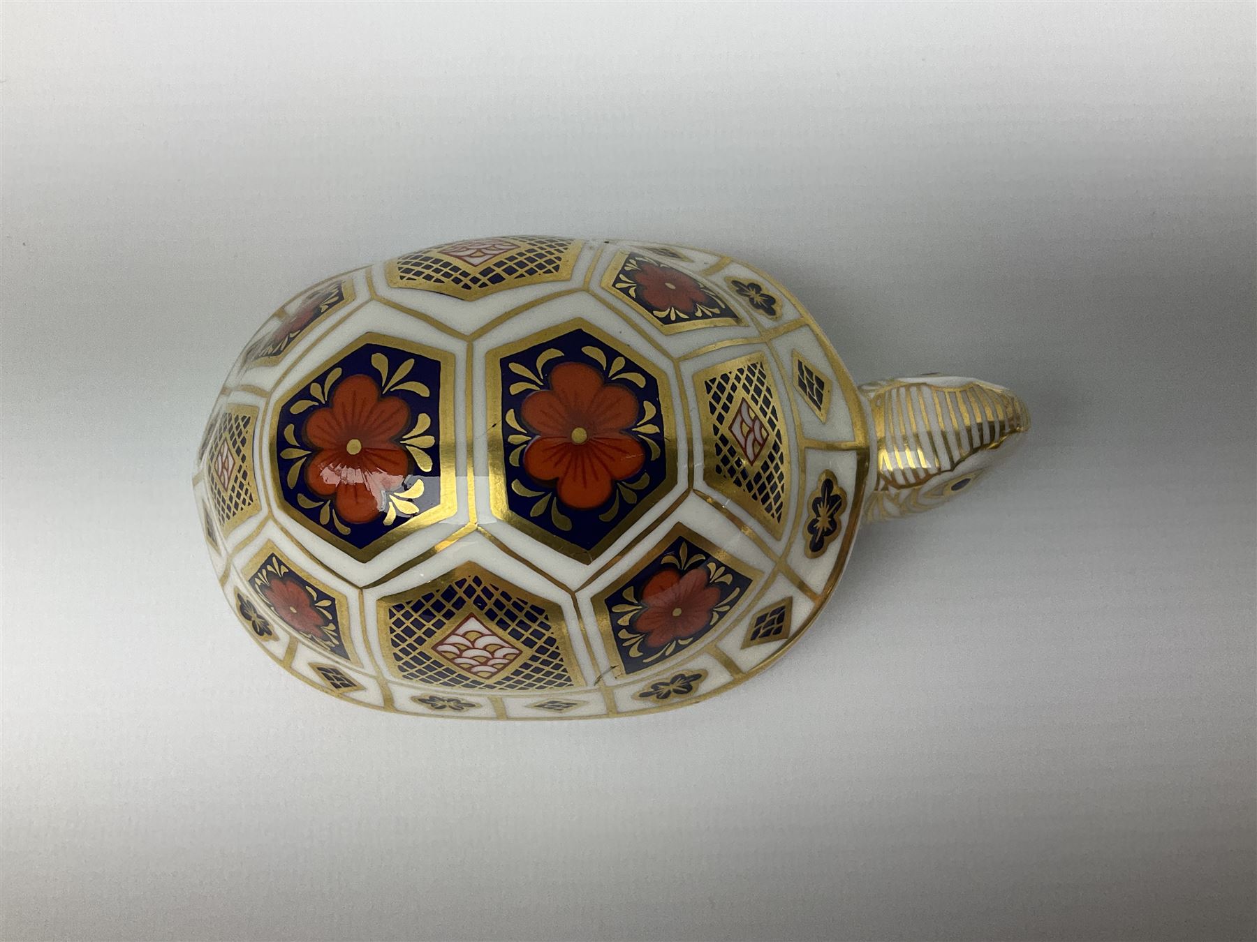 Royal Crown Derby tropical fish paperweight in the form of a Guppy, with a silver stopper, and Royal Crown Derby tortoise paperweight with gold stopper