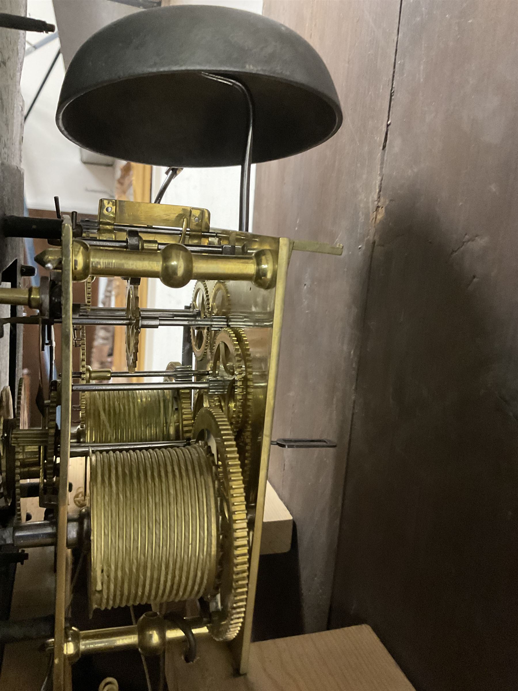 George Clapham of Brigg - Late 18th century 8-day oak cased longcase clock c1790 - flat topped hood with later carved addition, dog tooth moulding and blind fretwork beneath, break arch hood door flanked by reeded pilasters and capitals, trunk with canted corners and  door with a triple arched top, plinth with a later base with decoratively shaped feet, early painted dial with flowers enclosed in a gesso border to the spandrels, rolling moon to the arch, seconds dial and calendar aperture, Roman numerals and five minute Arabic's with makers name (indistinct), dial pinned via a false plate to a rack striking movement. With weights, key and pendulum.