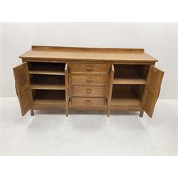 'Acornman' oak sideboard, rectangular top with raised back over four drawers and two double cupboards, the cupboards enclosed by panelled doors, panelled sides, on octagonal feet, by Alan Grainger of Brandsby, York