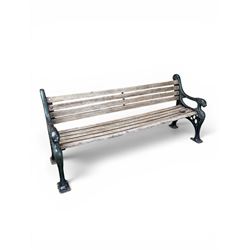 Neoclassical design cast iron and oak slatted garden bench, the twin end supports in the form of a Sphinx with acanthus carved knees and large paw feet, the pierced lattice bracket with Yorkshire rose motifs