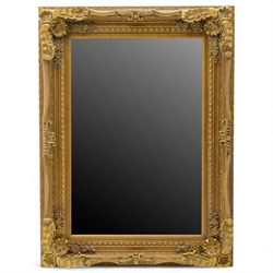 Late 19th century gilt composition overmantel mirror, rectangular bevelled plate within a ...