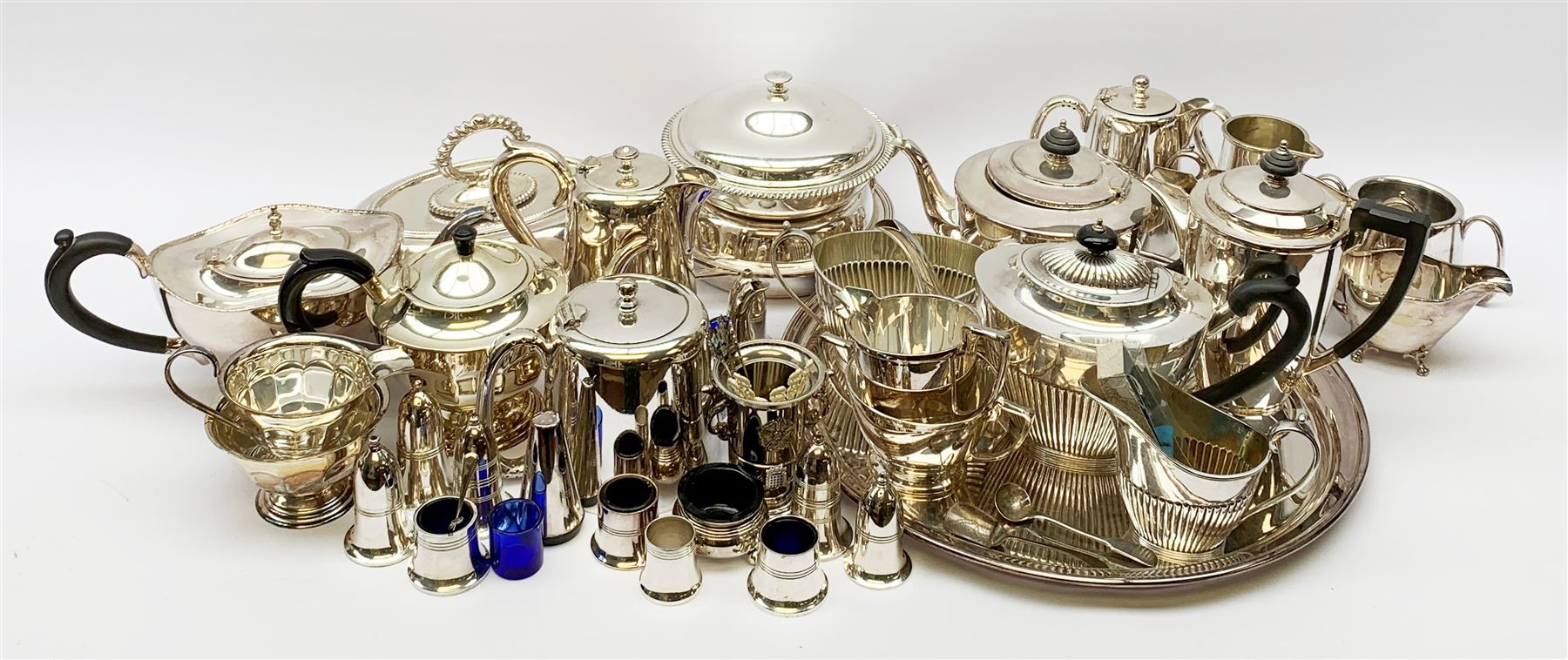 Mappin & Webb Art Deco style four-piece silver-plated tea set, a Mappin & Webb three-piece Princes Plate tea set of half fluted form with engraved monogram, two silver-plated entree dishes, circular tea tray, part cruets and other plated wares 