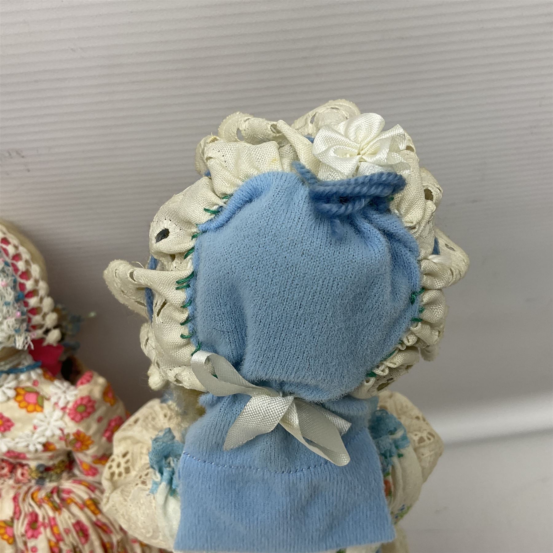 Anna Meszaros Hungary - three hand made needlewrok figurines - each wearing a lon floral dress and bonnet and holding a bouquet of flowers, tallest H32cm (3)  Auctioneer's Note: Anna Meszaros came to England from her native Hungary in 1959 to marry an English businessman she met while demonstrating her art at the 1958 Brussels Exhibition. Shortly before she left for England she was awarded the title of Folk Artist Master by the Hungarian Government. Anna was a gifted painter of mainly portraits and sculptress before starting to make her figurines which are completely hand made and unique, each with a character and expression of its own. The hands, feet and face are sculptured by layering the material and pulling the features into place with needle and thread. She died in Hull in 1998.