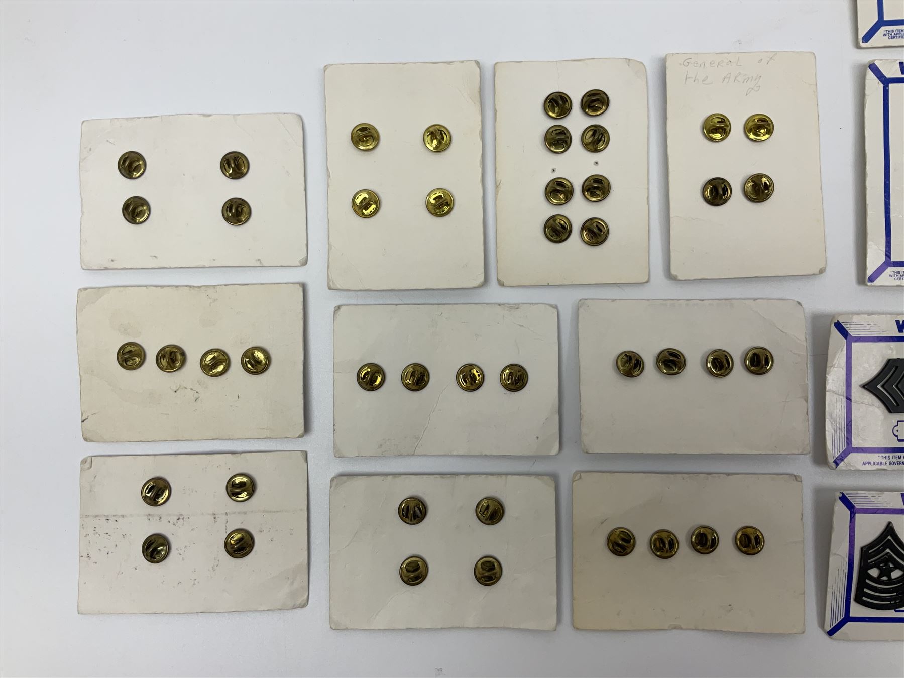 Fifty US rank badges and trade badges; WW2 and Vietnam period; predominantly on sale cards