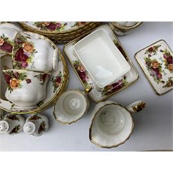 Royal Albert 'Old Country Roses' pattern tea and dinner service for eight, to include dinner plates, cereal bowls, teacups and saucers, oval serving dishes, cake plate, sauce boat and stand, placemats, pair of candlesticks, etc