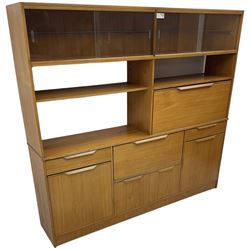 Mid-20th century teak sectional wall unit, combination of cupboards and drawers, raised sliding glass doors