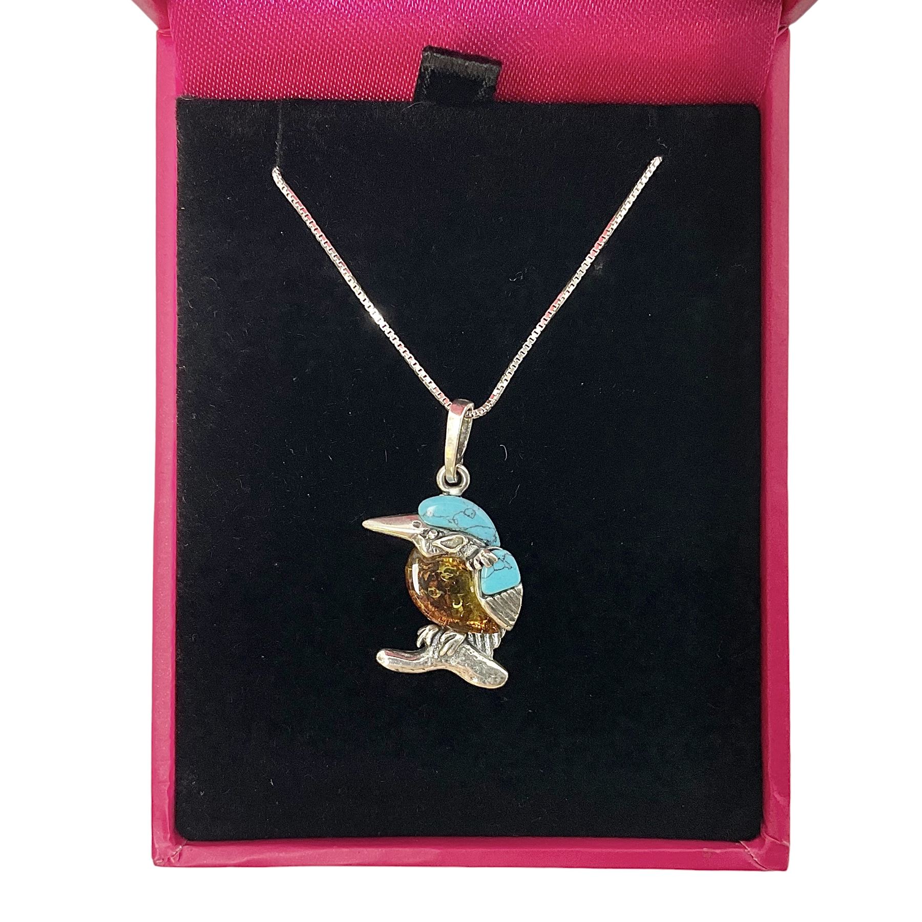 Silver Baltic Amber and Turquoise Kingfisher Pendant Necklace. Stamped 925.

This sweet little silver Kingfisher is made with Baltic Amber, also known as 'nature's time capsule' because of its prehistoric origins and ability to preserve organisms from millions of years ago. Paired with turquoise gemstones and some lovely detailing on the silver, this item makes for a very pretty piece of jewellery.  