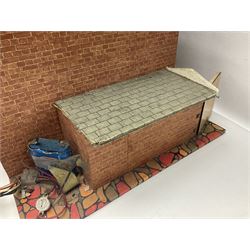 Scratch-built wooden doll's house of double fronted form with side garage, simulated brick walls under a faux tiled roof, the removable front elevation opening to reveal four partly furnished rooms on two floors with central staircase, wired for battery lighting; base L64cm D40cm H42cm
