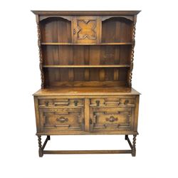 Early 20th century oak dresser, two-tier plate rack fitted with central cupboard and flanked by spiral turned uprights, base fitted with two drawers over two cupboards with geometric moulded facias, raised on barley twist supports