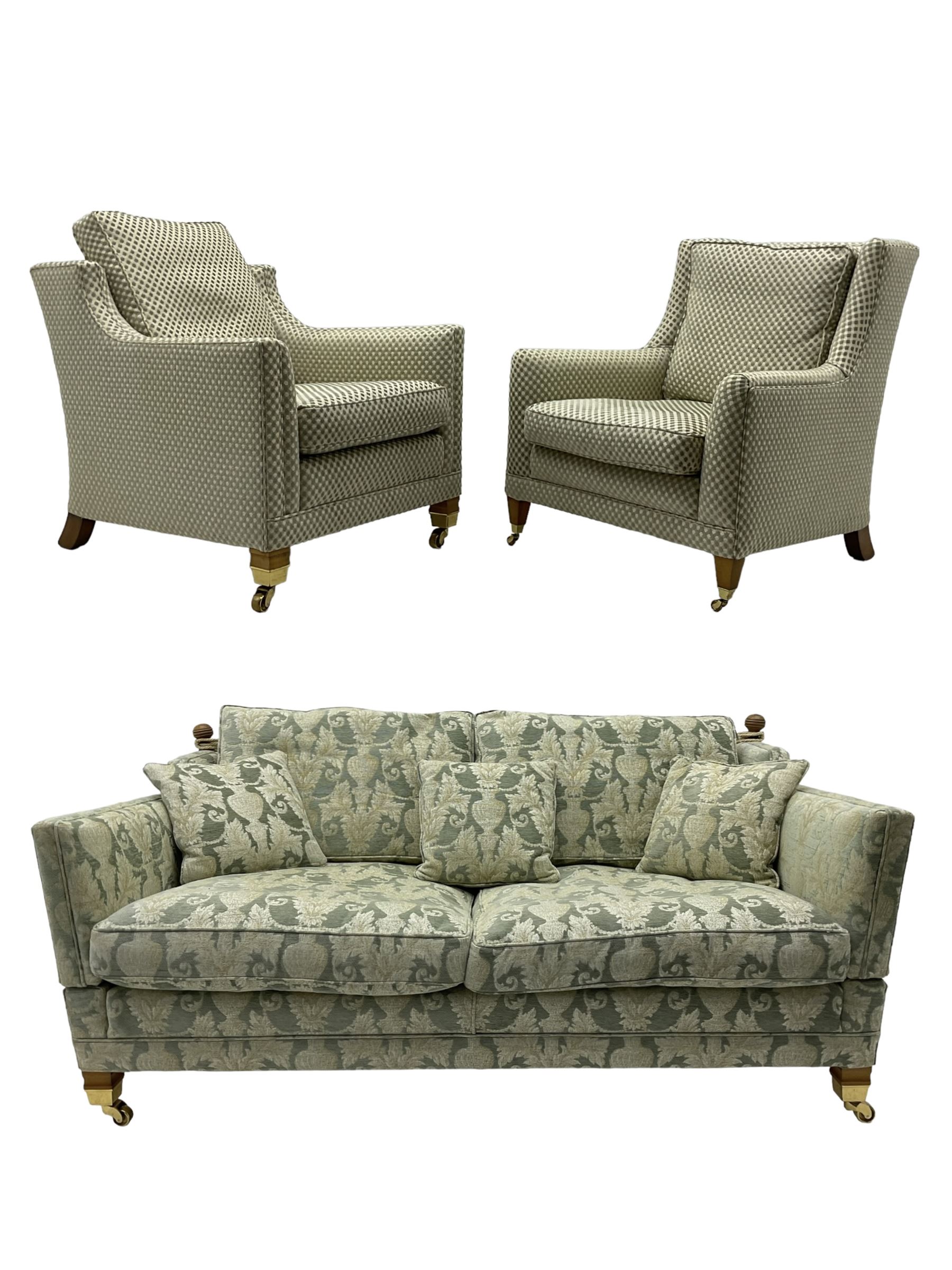 Three-piece hardwood-framed lounge suite - large two-seat Knole sofa with drop ends, upholstered in patterned fabric decorated with urns and foliage (W190cm, D117cm, H88cm); armchair upholstered in contrasting geometric pattern fabric (W83cm, D102cm, H93cm); and another armchair (W82cm, D102cm, H92cm) (3)