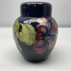 Moorcroft ginger jar, decorated in the Hibiscus pattern upon a cobalt blue ground,  with impressed Moorcroft, Made in England marks beneath and paper label detailed Potters to the late Queen Mary, H15cm