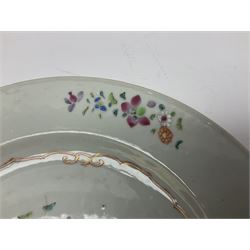 Three 18th century Chinese Famille Rose plates, the first example enamelled with blossoming peonies, rockwork and fence, the other two examples of similar design, decorated with blossoming peonies and sprigs within shaped inner borders, each approximately D23cm