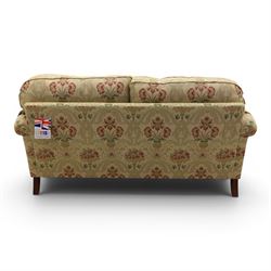 Parker Knoll - 'Henley' floral fabric living room suite, comprising a two seat sofa and pair of armchairs, raised on dark stained turned feet raised on brass castors

Armchairs (H 99cm, W 95cm, D 100cm)