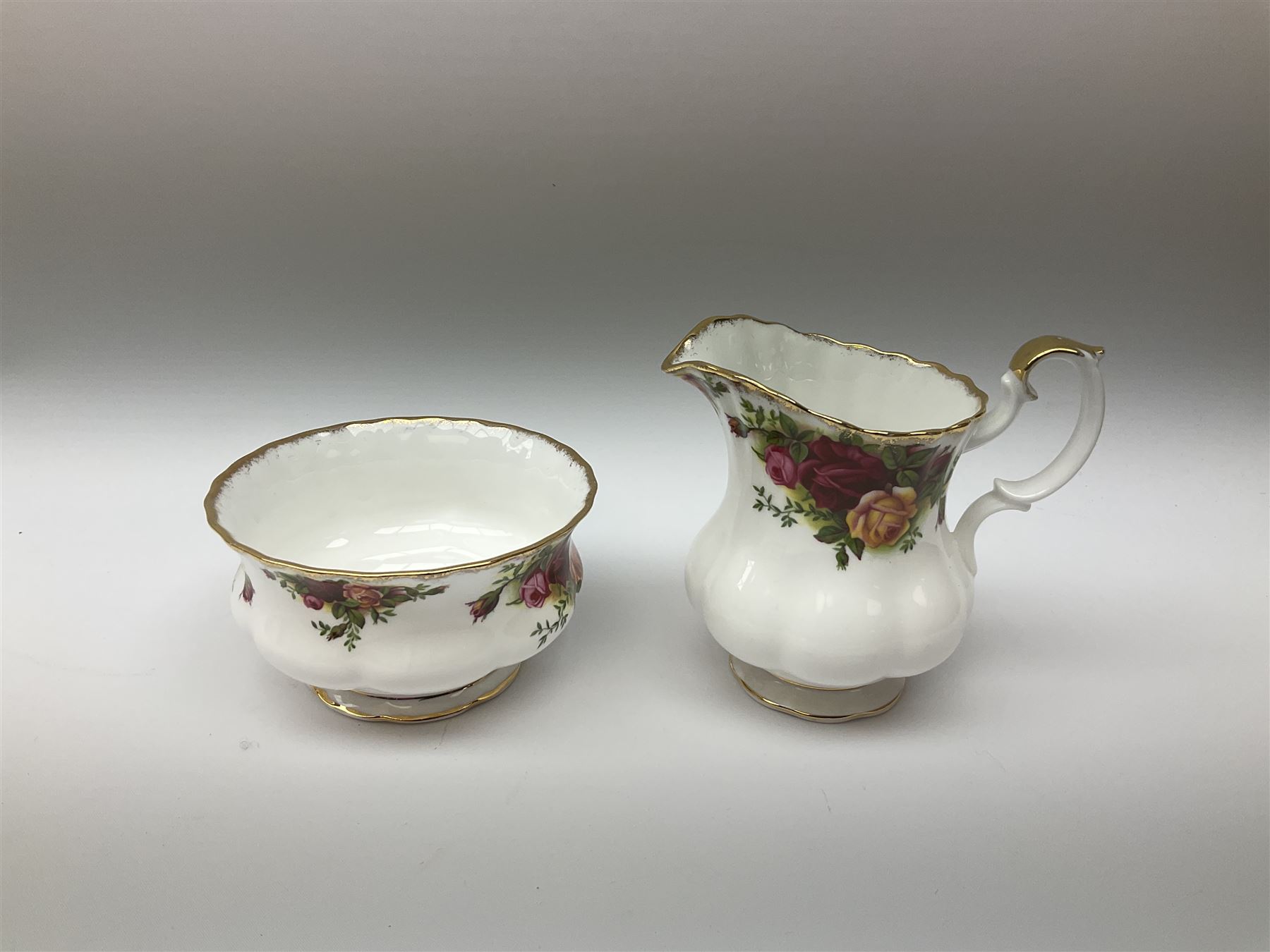 Royal Albert Old Country Roses pattern tea set, comprising teapot, coffee pot, six teacups and six saucers, five side plates, further teacup with joined saucer and side plate, open sucrier, milk jug, cake plate, and preserve pot and cover, together with Royal Albert Jubilee Rose pattern sauce boat and stand, and Royal Albert Lavender Rose pattern cake stand. 