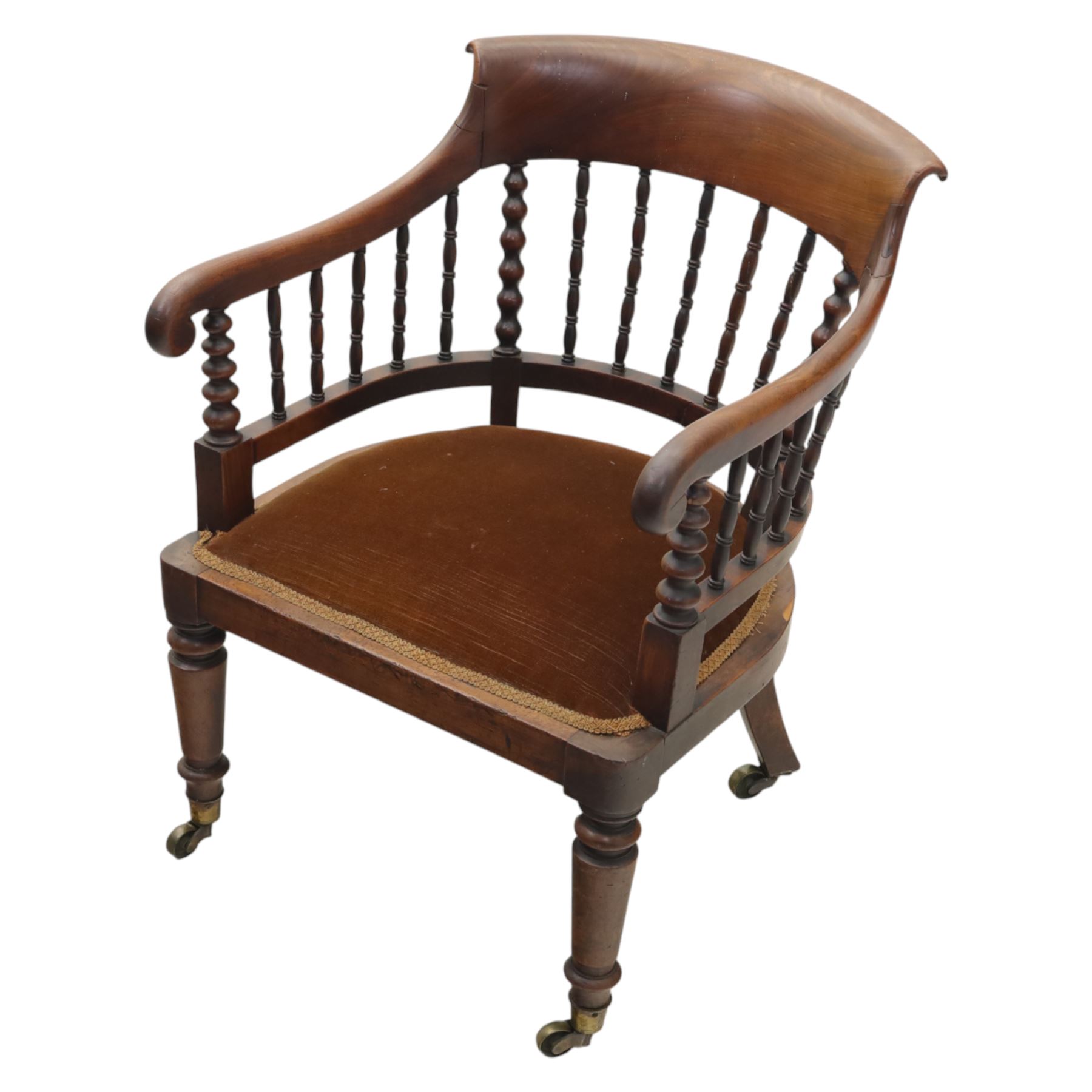 Late 19th-century captain's chair,  with spindle and bobbin turned shaped back, with brown velvet upholstered seat, raised on turned legs with brass castors, old damage and repairs 