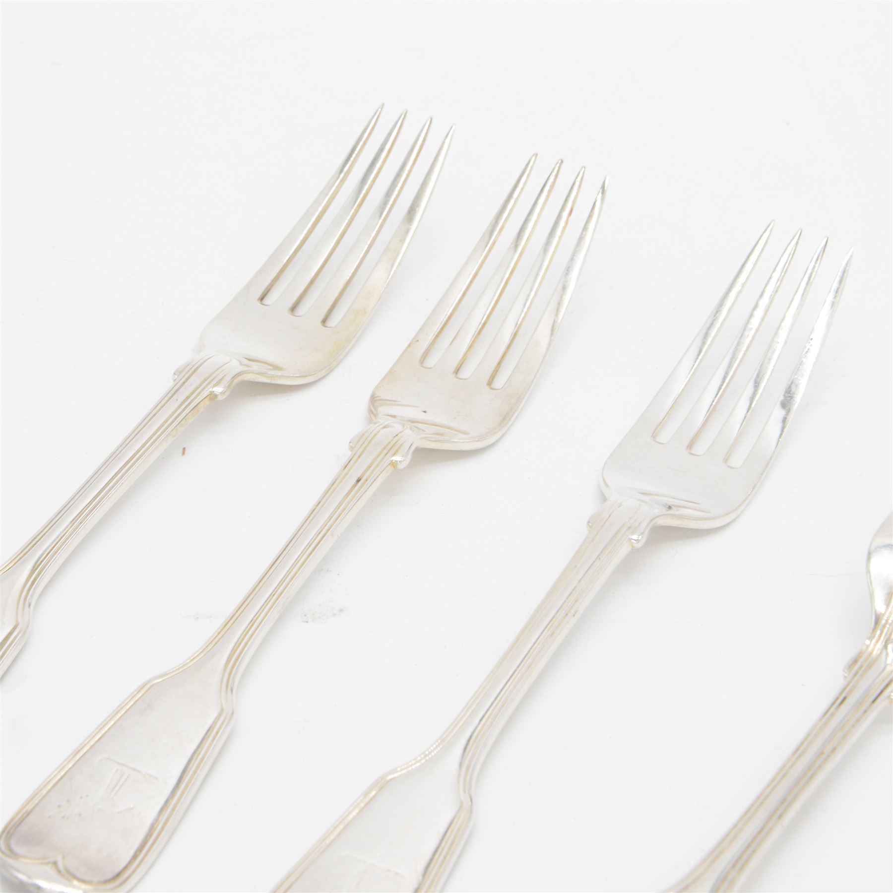 Five Victorian silver Fiddle pattern table forks, all engraved with crest to terminal, hallmarked The Portland Co, London 1861