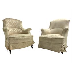  Two Victorian armchairs, upholstered in cream patterned fabric, on turned and ebonised front supports
