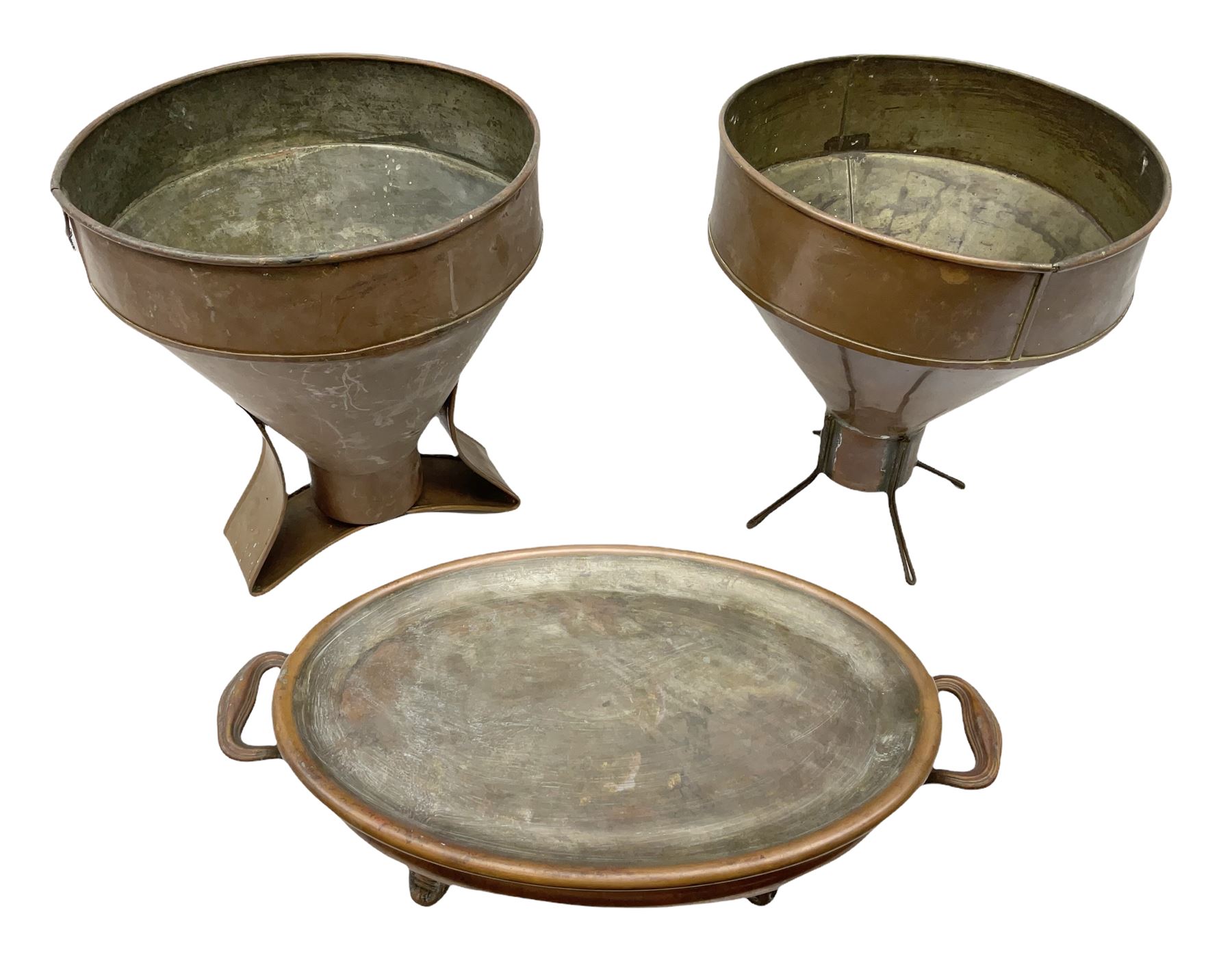 Agricultural copper corn funnel, H32.5cm, another similar copper funnel and copper warming platter of oval form, with twin handles on four supports, with removeable warming plate, L49cm