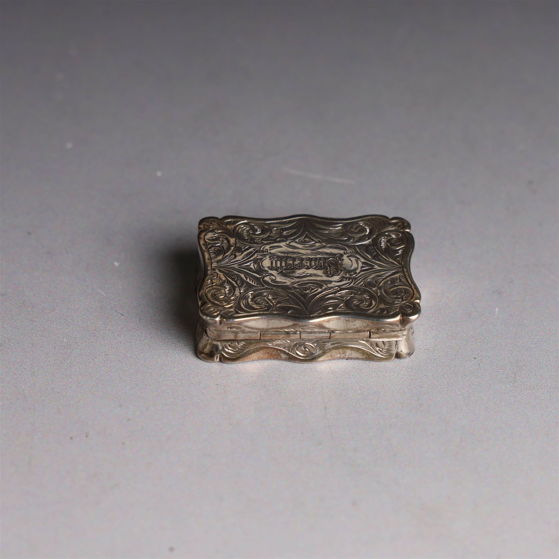Victorian silver vinaigrette, of typical shaped rectangular form, engraved 'Sincerity' to higned cover bordered by scrolling foliate decoration and with gilt interior, hallmarked Robert Thornton, London 1868