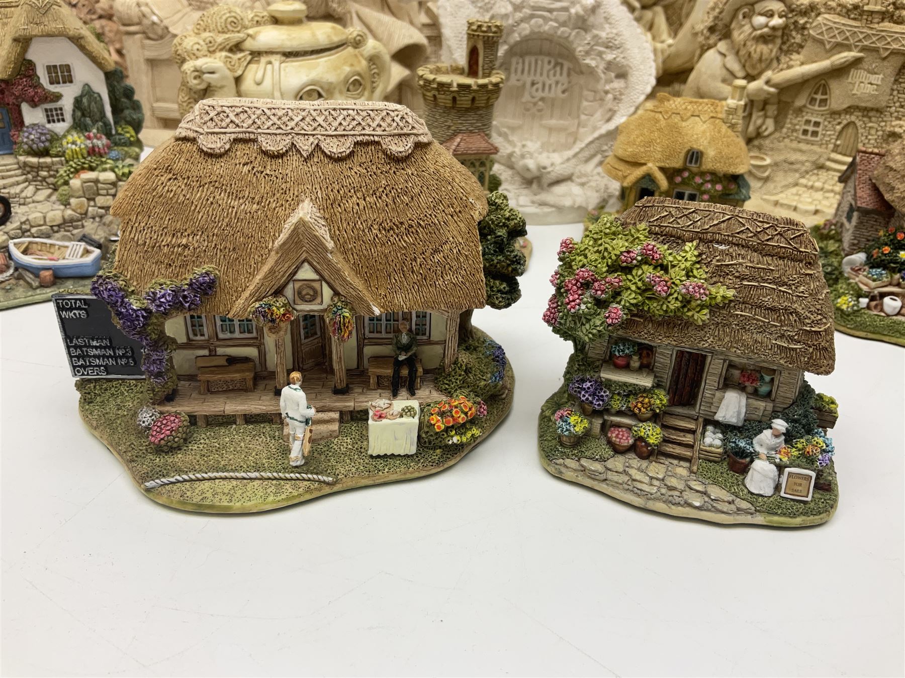 Thirty three Lilliput Lane models from the British collection and paint your own Children's Plaques, to include I am a little teapot, Gnome improvements, Dennis the Dragon, Bill and Ben, The Bobbins etc, some with boxes and deeds 