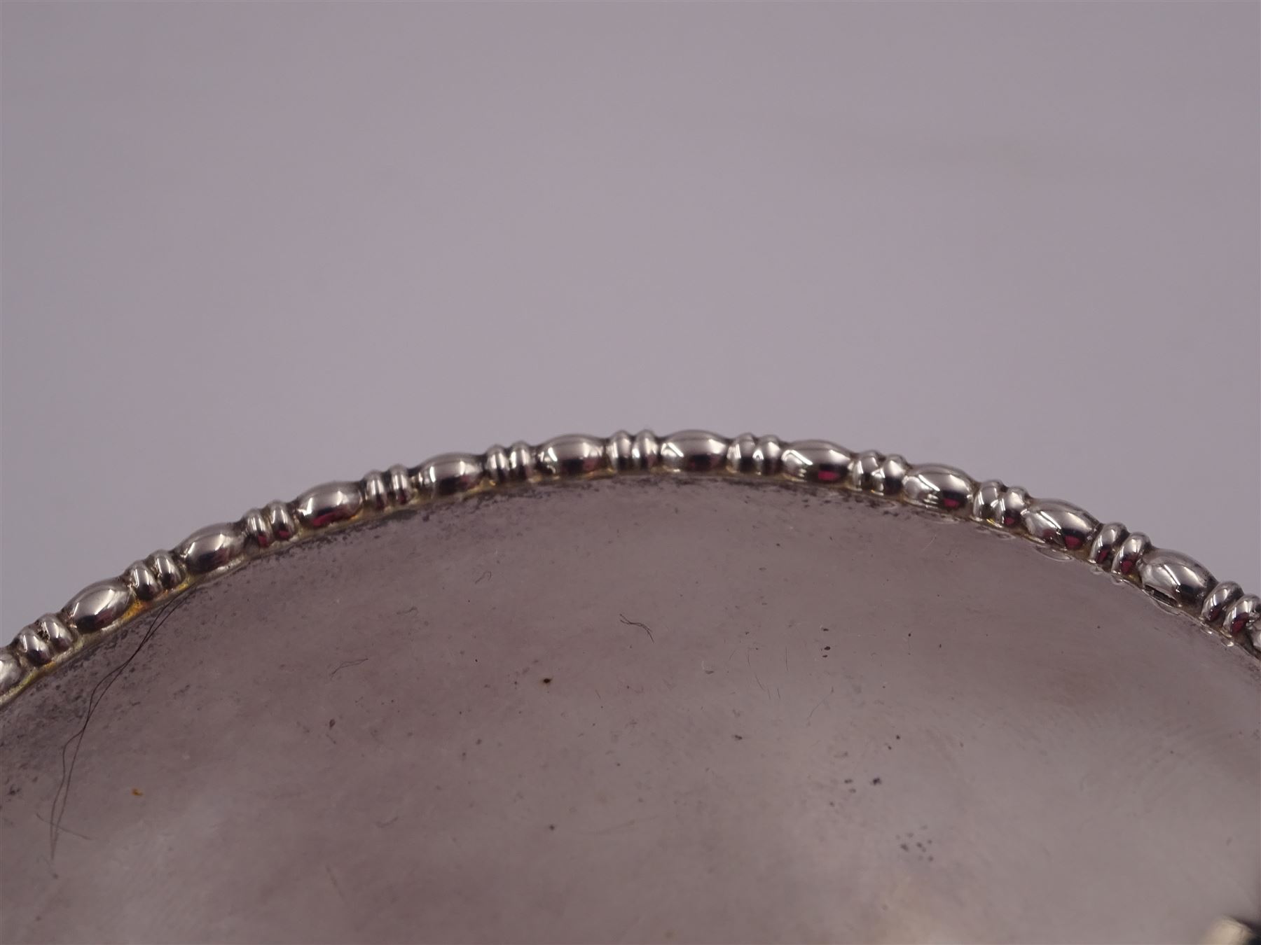 1920s silver mounted jewellery box, of circular form, with bead and dart rim to hinged cover, opening to reveal gilt velvet lined interior, upon four pad feet, hallmarked Charles Edwards, London 1920, H4.5cm