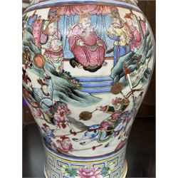 Large pair of 19th century Cantonese famille rose vases, each painted with various courtly scenes, including a display of warriors fighting on horseback before an official and his attendants, double Buddhist lion handles and applied at the shoulders with chilong, the lower band painted with Greek key motif, H58cm (2)