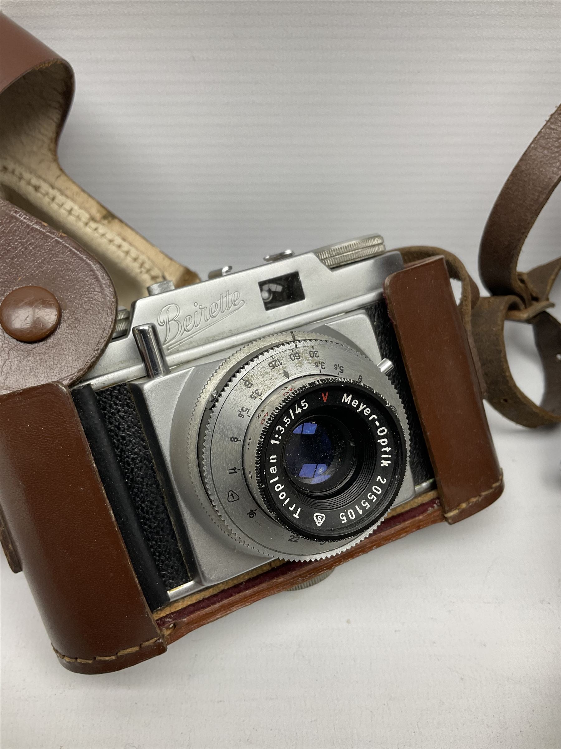 Ensign Ranger II folding roll film camera, Beirette Junior II camera and Bell & Howell 624 EE Autoset hand-wind cine camera, all in cases