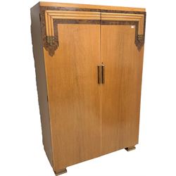 Art Deco period oak and walnut burr wardrobe, two doors enclosing three linen slides and two drawers, sledge feet base (W122cm, H186cm, D52cm) a chest of drawers, two cupboard doors above two drawers, sledge feet base (W76cm, H106cm, D47cm) a dressing table, raised three piece mirror back, two short and one long drawer (W107cm, H160cm, D56cm) and a 4'6 double bed frame (W137cm, H127cm, L210cm)