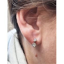 Pair of platinum and gold old cut diamond pendant stud earrings, milgrain set diamond suspending from five claw set diamond, total diamond weight approx 0.95 carat