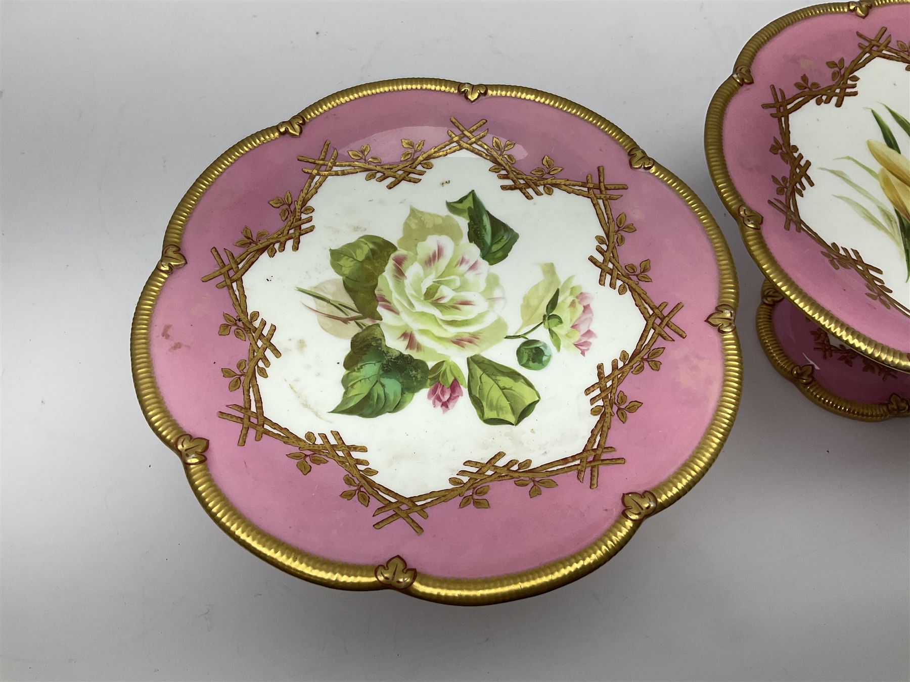 Victorian dessert service, comprising four comports and nine plates, each decorated with floral sprigs to the centre with a pink and gilt border, largest comport H13cm, plate D22.5cm