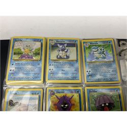 Collection of Pokemon trading cards, mostly 1999 Wizards Pokemon cards to include holo Charizard 4/102, first edition holo Machamp 8/102, further holographic cards; Dark Flareon 35/82 and Dark Vaporeon 45/82, cards from themed sets and 4th edition prints; 1998 Electronic Pokédex with cardboard boxes for themed decks Blackout, Overgrowth and Power Reserve Jungle, along with a large quantity of energy and trainer cards 