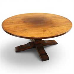 Early 20th century oak centre table, the large circular top raised on a squared and turned baluster pedestal, terminating to four splayed supports