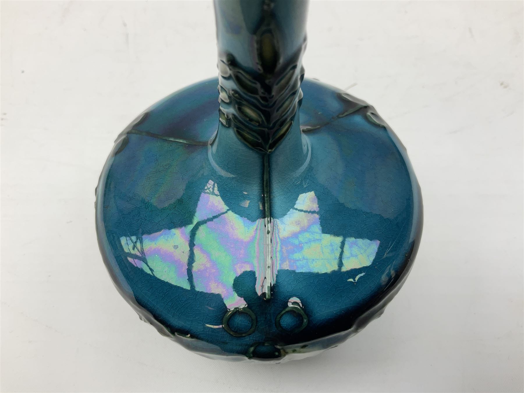 Minton Secessionist vase, with tube-lined stylised flower decoration, upon a blue ground, with printed mark to base 'Minton Ltd, No. 32', H13cm