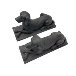 Pair of composite recumbent Labrador figures
