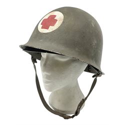 French Algerian War Red Cross steel helmet, marked 'CP ICA Esperaza 1955'; green finish with crudely painted Red Cross logo to the front