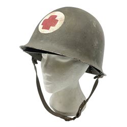 French Algerian War Red Cross steel helmet, marked 'CP ICA Esperaza 1955'; green finish with crudely painted Red Cross logo to the front