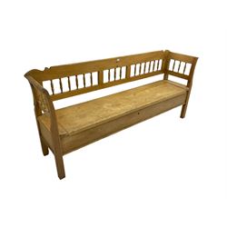 Pine bench, spindle back over hinged box seat, raised on square supports