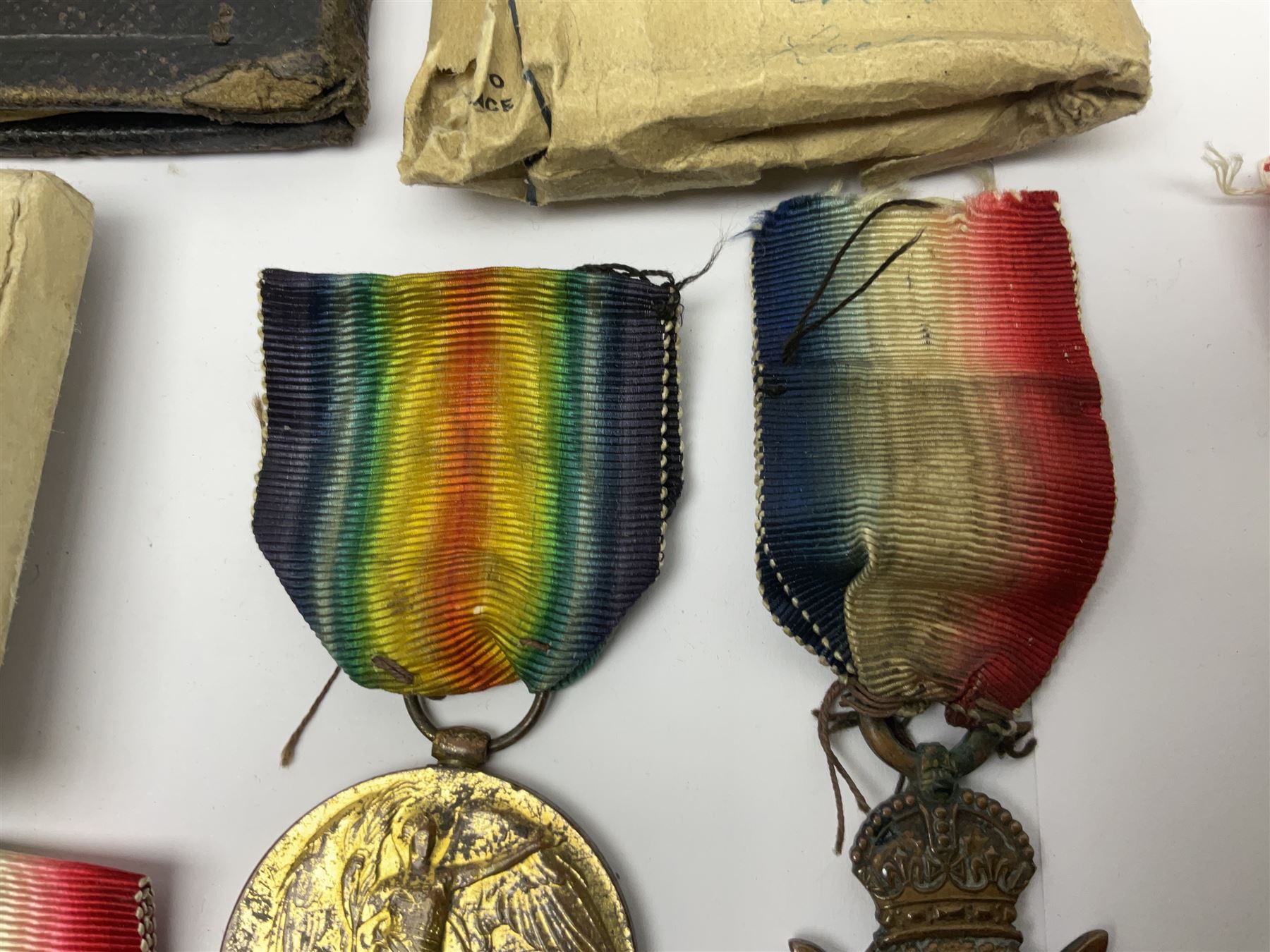 WWI pair of medals comprising British War Medal and Victory Medal awarded to 32682 Pte. W. Meadows W. Rid. R. in issue box; WWI pair of medals comprising 1914-15 Star and Victory Medal awarded to 3720 Pte. (later Cpl.) E. Petty W. York. R. with issue letter from Tank Corps; WWII group of five medals comprising 1939-45 War Medal, Defence Medal and 1939-45, Italy and Africa Stars; all with ribbons; and book of nineteen seaman's Certificates of Discharge to cook Charles Filburn 1893 - 1901 from various British ports