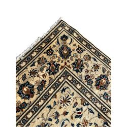 Persian Nain ivory ground rug, the field decorated with trailing leafy branches and palmettes, matching border within guard stripes