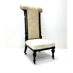 Victorian ebonised prie dieu chair upholstered in an ivory ground fabric, turned reeded and tapering supports