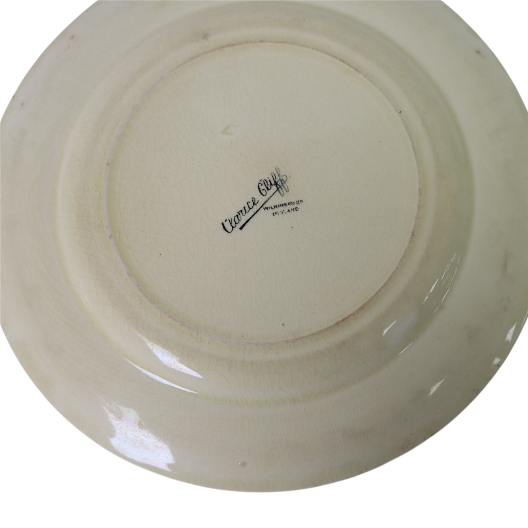 Clarice Cliff Secrets pattern plates, circa 1933, hand painted with a shoulder variant of a tree and cottage landscape, with Bizarre and printed marks to base, D23cm and D18cm