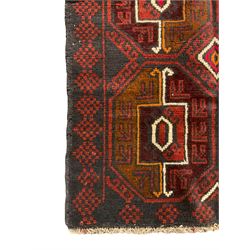 Baluchi red and blue ground rug, the field decorated with large six Gul motifs