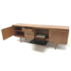 Greaves and Thomas teak sideboard, three graduating drawers, fall front unit, flanked by two cupboard doors, shaped supports 